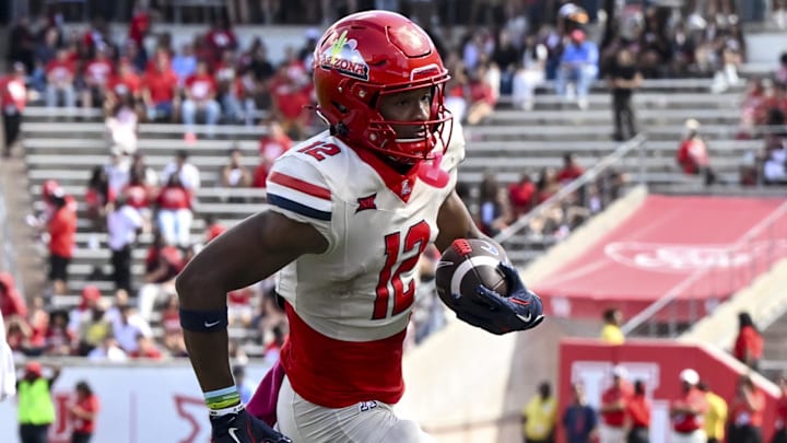 Oct 18, 2025; Houston, Texas, USA; Arizona Wildcats wide receiver Tre Spivey (12) runs the ball in for a touchdown during the fourth quarter against the Houston Cougars at TDECU Stadium. Mandatory Credit: Maria Lysaker-Imagn Images 