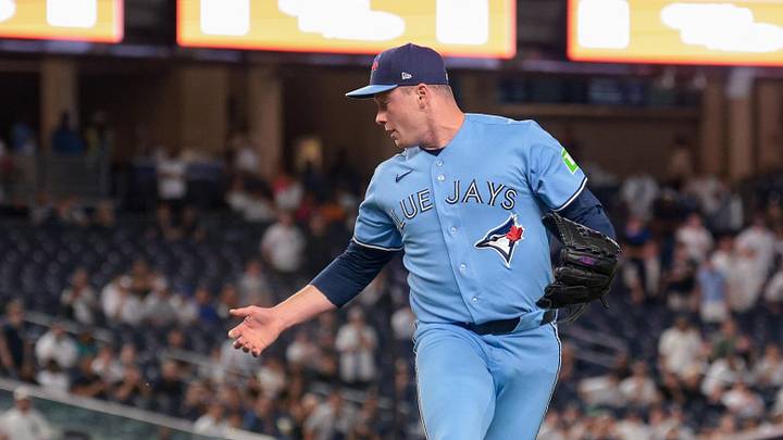 May 20, 2026; Bronx, New York, USA; Toronto Blue Jays pitcher Louis Varland (77) can not handle a ball off the bat of New York Yankees second baseman Jazz Chisholm Jr. (not pictured) during the ninth inning at Yankee Stadium. Mandatory Credit: Vincent Carchietta-Imagn Images