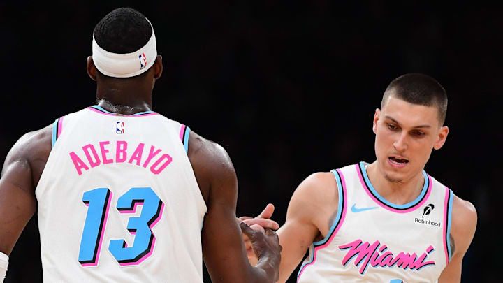 Apr 2, 2025; Boston, Massachusetts, USA; Miami Heat center Bam Adebayo (13) is congratulated by guard Tyler Herro (14) after making a basket during the second half against the Boston Celtics at TD Garden. Mandatory Credit: Bob DeChiara-Imagn Images