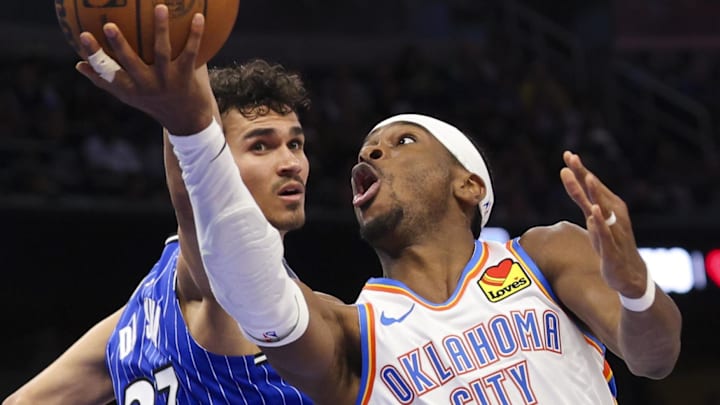 klahoma City Thunder guard Shai Gilgeous-Alexander drives to the basket past Orlando Magic forward Tristan da Silva.