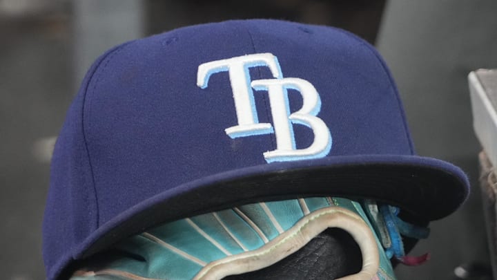 Sep 26, 2025; Toronto, Ontario, CAN; The hat and glove of Tampa Bay Rays third baseman Junior Caminero (13) in the dugout during the game against the Toronto Blue Jays at Rogers Centre. 