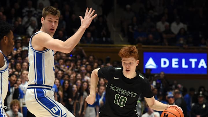 Nov 6, 2023; Durham, North Carolina, USA; Dartmouth Big Green guard Ryan Cornish (10) controls the ball in front of Duke Blue Devils center Kyle Filipowski(30) during the first half at Cameron Indoor Stadium. Mandatory Credit: Rob Kinnan-Imagn Images