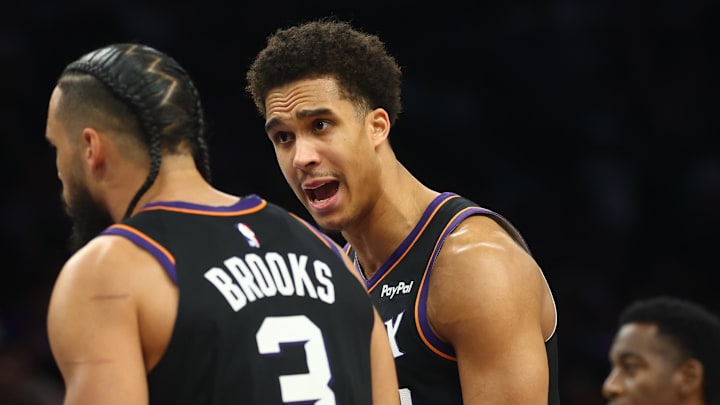 Phoenix Suns center Oso Ighodaro (right) argues with Dillon Brooks against the Golden State Warriors during the second half in the play-in rounds of the 2026 NBA Playoffs at Mortgage Matchup Center.