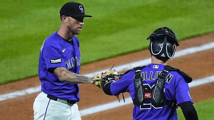 Colorado Rockies pitcher Kyle Freeland (21) and catcher Brett Sullivan (26) high-five. 