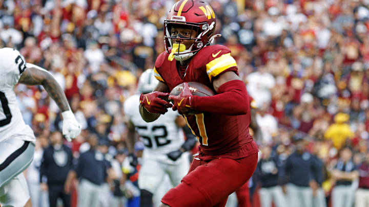 Sep 21, 2025; Landover, Maryland, USA; Washington Commanders wide receiver Terry McLaurin (17) runs the ball during the second half as Las Vegas Raiders safety Isaiah Pola-Mao (20) defends at Northwest Stadium. Mandatory Credit: Amber Searls-Imagn Images