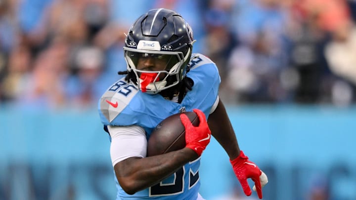 Dec 28, 2025; Nashville, Tennessee, USA;  Tennessee Titans tight end Chigoziem Okonkwo (85) runs with the ball after a made catch against the New Orleans Saints during the first half at Nissan Stadium. Mandatory Credit: Steve Roberts-Imagn Images