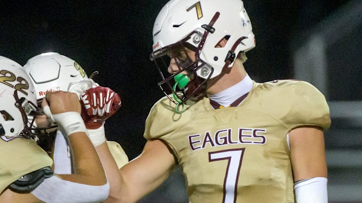 Dunlap’s Mack Sutter (7) bumps fists with teammates Blake Dietz (22) and Joseph Weeks as the Eagles battled Galesburg on the opening night of high school football Friday, Aug. 30, 2024 at Dunlap High School.