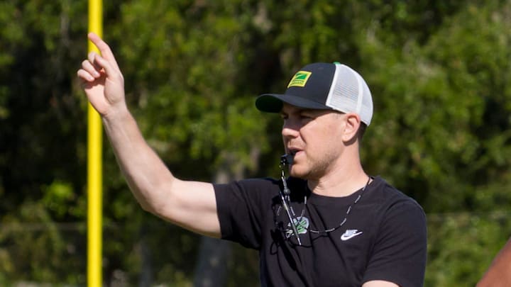 Oregon offensive coordinator Will Stein walks the field as the Oregon Ducks practice at Barry University ahead of the Orange Bowl on Dec. 30, 2025, in Miami, Florida.