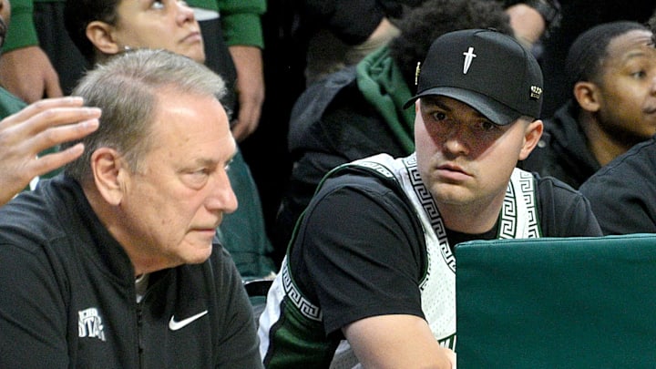 Jan 19, 2025; East Lansing, Michigan, USA;  Tigers Cy Young award winner Tarik Skubal watches Michigan State Spartans head coach Tom Izzo during the first half against the Illinois Fighting Illini at Jack Breslin Student Events Center. Mandatory Credit: Dale Young-Imagn Images