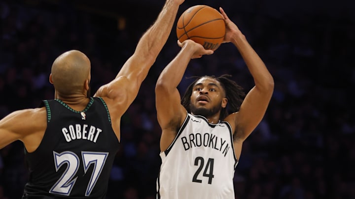 Dec 27, 2025; Minneapolis, Minnesota, USA; Brooklyn Nets guard Cam Thomas (24) shoots against Minnesota Timberwolves center Rudy Gobert (27) in the third quarter at Target Center. Mandatory Credit: Bruce Kluckhohn-Imagn Images