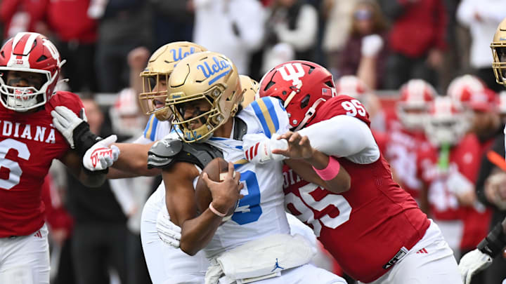 Oct 25, 2025; Bloomington, Indiana, USA; Indiana Hoosiers defensive lineman Tyrique Tucker (95) brings down UCLA Bruins quarterback Nico Iamaleava (9) during the first half at Memorial Stadium. Mandatory Credit: Robert Goddin-Imagn Images