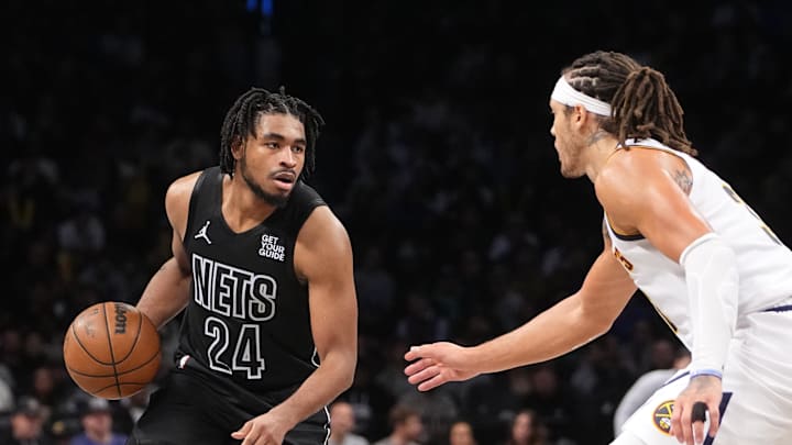 Oct 29, 2024; Brooklyn, New York, USA; Brooklyn Nets small guard Cam Thomas (24) dribbles the ball against Denver Nuggets power forward Aaron Gordon (32) during  the second half at Barclays Center. Mandatory Credit: Gregory Fisher-Imagn Images