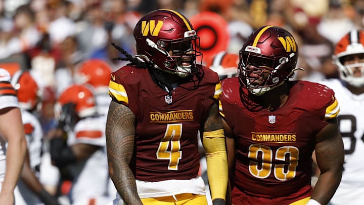 Oct 6, 2024; Landover, Maryland, USA; Washington Commanders linebacker Frankie Luvu (4) and Commanders defensive tackle Jonathan Allen (93) celebrate after a sack of Cleveland Browns quarterback Deshaun Watson (not pictured) during the second quarter at NorthWest Stadium. Mandatory Credit: Geoff Burke-Imagn Images