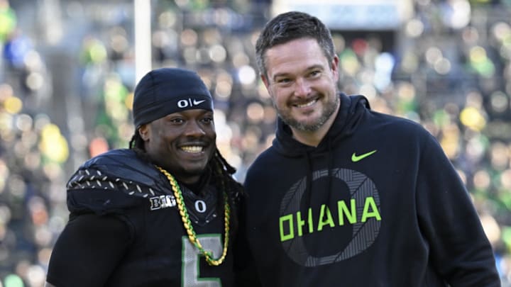 Nov 22, 2025; Eugene, Oregon, USA; Oregon Ducks running back Noah Whittington (6) poses for a photo with head coach Dan Lanning before the game against the Southern California Trojans at Autzen Stadium. Mandatory Credit: Troy Wayrynen-Imagn Images Nov 22, 2025; Eugene, Oregon, USA; Oregon Ducks running back Noah Whittington (6) poses for a photo with head coach Dan Lanning before the game against the Southern California Trojans at Autzen Stadium. Mandatory Credit: Troy Wayrynen-Imagn Images