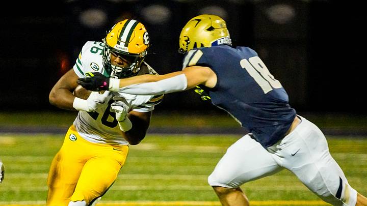 St. Edward's Tyrese Buchanan (26) is brought down by Hoban’s Brayton Feister (18), right, Oct. 24, 2025, at Dowed Field in Akron, Ohio. St. Edward's Tyrese Buchanan (26) is brought down by Hoban’s Brayton Feister (18), right, Oct. 24, 2025, at Dowed Field in Akron, Ohio.