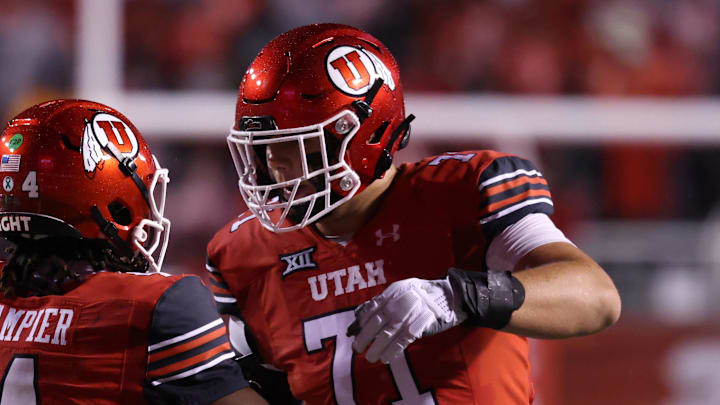 Oct 11, 2025; Salt Lake City, Utah, USA; Utah Utes quarterback Devon Dampier (4) celebrates scoring a touchdown against the Arizona State Sun Devils with Utah Utes offensive lineman Caleb Lomu (71) during the second quarter at Rice-Eccles Stadium. Mandatory Credit: Rob Gray-Imagn Images