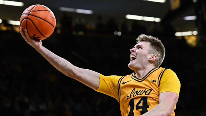 Feb 25, 2026; Iowa City, Iowa, USA; Iowa Hawkeyes guard Bennett Stirtz (14) goes to the basket against the Ohio State Buckeyes during the second half at Carver-Hawkeye Arena. Mandatory Credit: Jeffrey Becker-Imagn Images