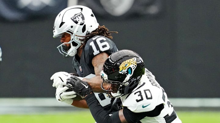 Nov 2, 2025; Paradise, Nevada, USA; Jacksonville Jaguars cornerback Montaric Brown (30) tackles Las Vegas Raiders wide receiver Jakobi Meyers (16) during the second half at Allegiant Stadium. Mandatory Credit: Stephen R. Sylvanie-Imagn Images