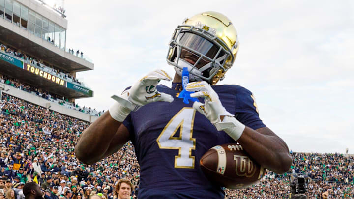 Notre Dame running back Jeremiyah Love (4) makes a heart sign after scoring a touchdown in the first half of a NCAA football game against Syracuse at Notre Dame Stadium on Saturday, Nov. 22, 2025, in South Bend.