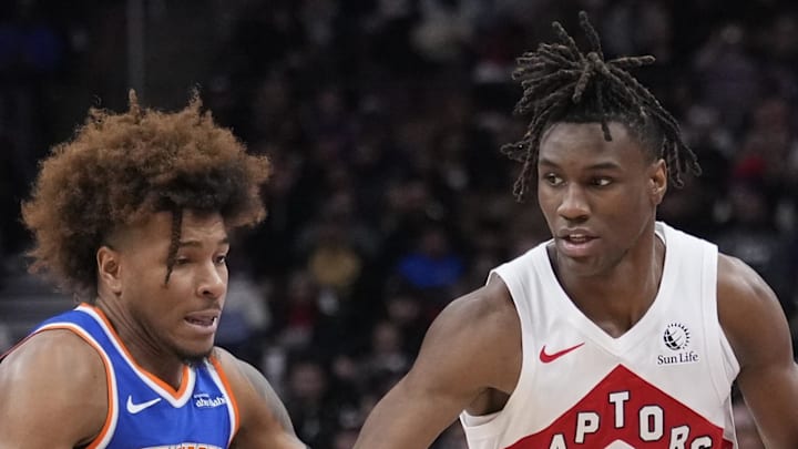 Toronto Raptors guard Ja'Kobe Walter drives to the paint against New York Knicks guard Miles McBride.