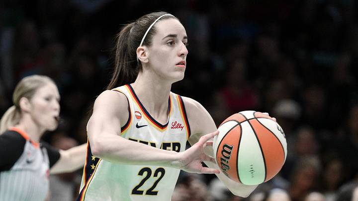 Indiana Fever guard Caitlin Clark (22) passes the ball against the New York Liberty. Indiana Fever guard Caitlin Clark (22) passes the ball against the New York Liberty.
