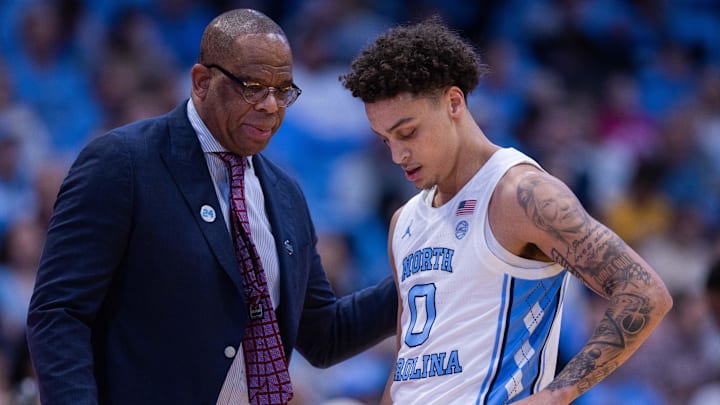 Dec 22, 2025; Chapel Hill, North Carolina, USA; North Carolina Tar Heels head coach Hubert Davis talks with guard Kyan Evans (0) 