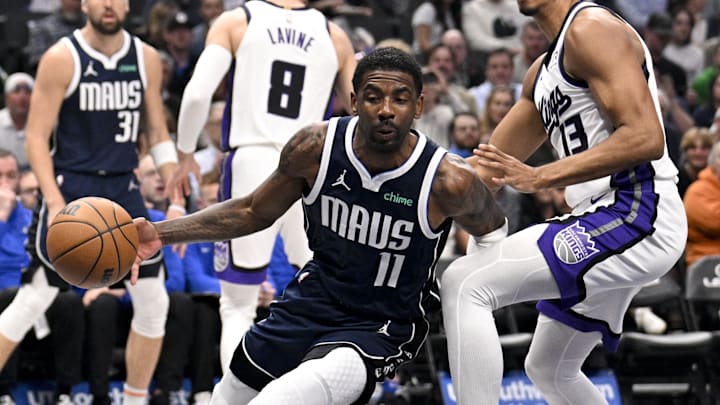 Mar 3, 2025; Dallas, Texas, USA; Dallas Mavericks guard Kyrie Irving (11) drives to the basket past Sacramento Kings forward Keegan Murray (13) during the first quarter at the American Airlines Center. Mandatory Credit: Jerome Miron-Imagn Images