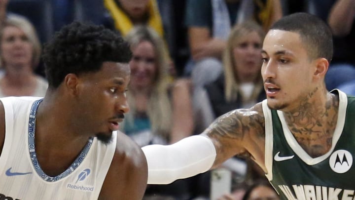 Memphis Grizzlies forward/center Jaren Jackson Jr. handles the ball as Milwaukee Bucks forward Kyle Kuzma defends.