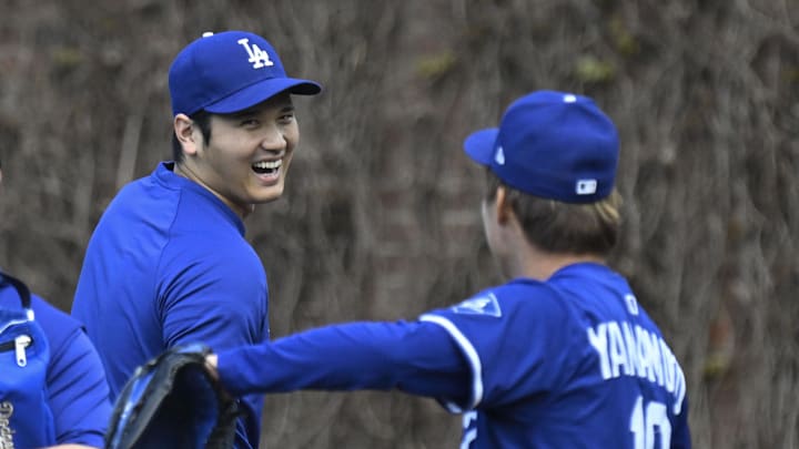 Apr 23, 2025; Chicago, Illinois, USA; Los Angeles Dodgers two-way player Shohei Ohtani (17) laughs with pitcher Yoshinobu Yamamoto (18) before the teams game against the Chicago Cubs at Wrigley Field. Mandatory Credit: Matt Marton-Imagn Images Apr 23, 2025; Chicago, Illinois, USA; Los Angeles Dodgers two-way player Shohei Ohtani (17) laughs with pitcher Yoshinobu Yamamoto (18) before the teams game against the Chicago Cubs at Wrigley Field. Mandatory Credit: Matt Marton-Imagn Images