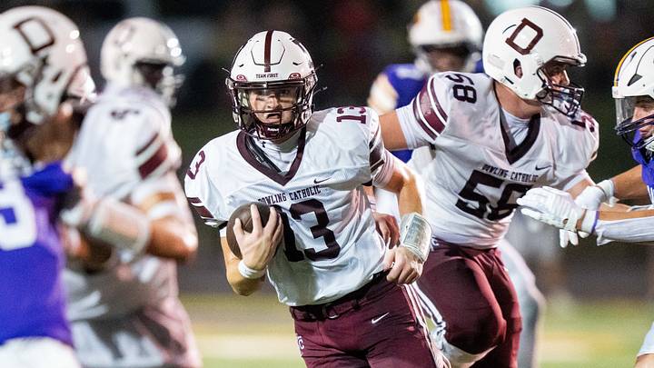 Dowling Catholic's Ethan La Cava (13) carries the ball up the field against Johnston on Sept. 4, 2026, at Johnston High School.