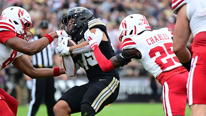 Sep 28, 2024; West Lafayette, Indiana, USA; Purdue Boilermakers running back Devin Mockobee is tackled by Nebraska Cornhuskers defensive backs DeShon Singleton (8) and Jeremiah Charles (25) during the second quarter.