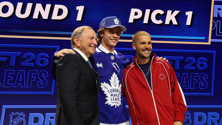 Jun 26, 2026; Buffalo, New York, USA; Gavin McKenna poses with NHL commissioner Gary Bettman and singer Justin Bieber after being selected with the first pick in the first round of the 2026 NHL Draft by the Toronto Maple Leafs at KeyBank Center. Mandatory Credit: Timothy T. Ludwig-Imagn Images