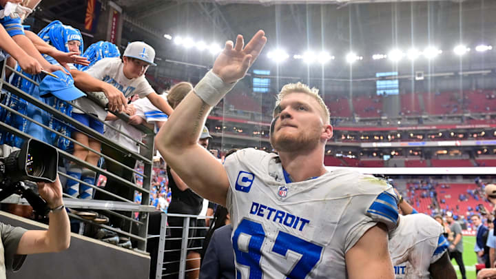 Detroit Lions defensive end Aidan Hutchinson (97) celebrates with fans after beating the Cardinals Detroit Lions defensive end Aidan Hutchinson (97) celebrates with fans after beating the Cardinals