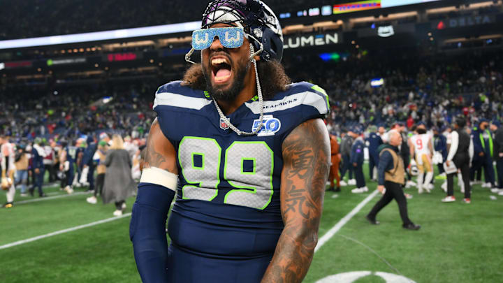 Seattle Seahawks DE Leonard Williams celebrates on the field following an NFC Divisional Round game against the 49ers.
