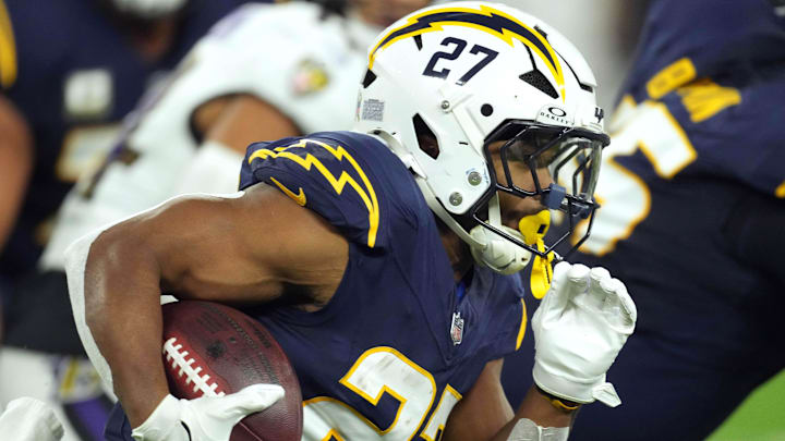 Nov 25, 2024; Inglewood, California, USA; Los Angeles Chargers running back J.K. Dobbins (27) carries the ball against the Baltimore Ravens in the first half at SoFi Stadium. Mandatory Credit: Kirby Lee-Imagn Images