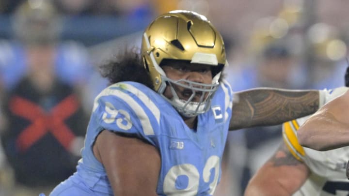 Nov 8, 2024; Pasadena, California, USA;  UCLA Bruins defensive lineman Jay Toia (93) pressures Iowa Hawkeyes quarterback Jackson Stratton (19) as he throws a pass in the second half at the Rose Bowl. Mandatory Credit: Jayne Kamin-Oncea-Imagn Images