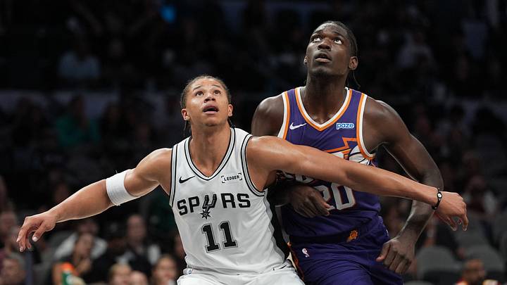 Oct 14, 2026; San Antonio, Texas, USA; San Antonio Spurs forward Carter Bryant (11) blocks out Phoenix Suns forward Rasheer Fleming (20) in the second half at Frost Bank Center. Oct 14, 2026; San Antonio, Texas, USA; San Antonio Spurs forward Carter Bryant (11) blocks out Phoenix Suns forward Rasheer Fleming (20) in the second half at Frost Bank Center.