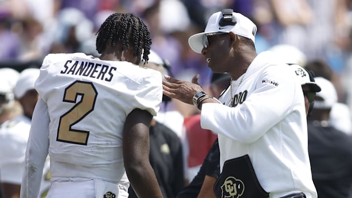 Sep 2, 2023; Fort Worth, Texas, USA; Colorado Buffaloes head coach Deion Sanders talks to quarterback Shedeur Sanders (2) after a touchdown in the fourth quarter against the TCU Horned Frogs at Amon G. Carter Stadium. Mandatory Credit: Tim Heitman-Imagn Images