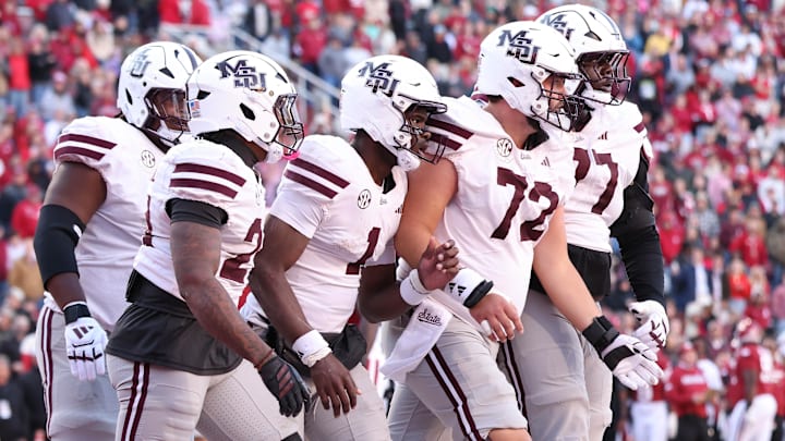 Mississippi State Bulldogs quarterback Kamario Taylor (1) celebrates with teammates after scoring a touchdown during the third quarter against the Arkansas Razorbacks at Donald W. Reynolds Razorback Stadium. Bulldogs won 38-35.