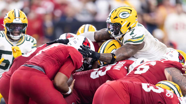 Oct 19, 2025; Glendale, Arizona, USA; Arizona Cardinals quarterback Jacoby Brissett (left) is stopped by Green Bay Packers linebacker Quay Walker on a fourth and one attempt in the fourth quarter at State Farm Stadium. Mandatory Credit: Mark J. Rebilas-Imagn Images