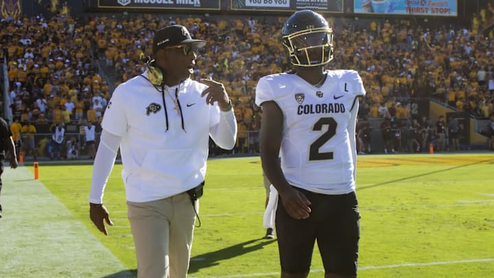 Oct 7, 2023; Tempe, Arizona, USA; Colorado Buffaloes head coach Deion Sanders with son and quarterback Shedeur Sanders (2) against the Arizona State Sun Devils at Mountain America Stadium. Mandatory Credit: Mark J. Rebilas-Imagn Images