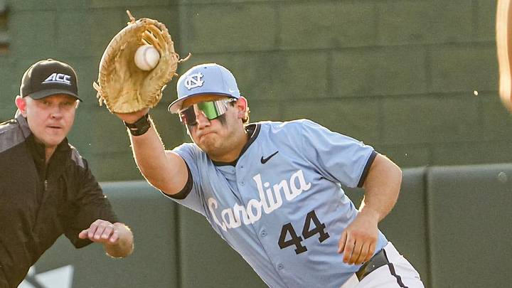 Clemson outfielder Bryce Clavon (1) dives back to first under the tag of University of North Carolina junior Erik Paulsen (44) during the bottom of the third inning at Doug Kingsmore Stadium in Clemson, S.C. Friday, April 10, 2026.