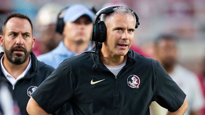 Florida State Seminoles head coach Mike Norvell talks on his headset as he coaches from the sideline. The Florida State Seminoles defeated the Virginia Tech Hokies 39-17 at Doak Campbell Stadium on Saturday, Oct. 7, 2023.
