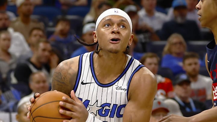 Mar 3, 2026; Orlando, Florida, USA;  Orlando Magic forward Paolo Banchero (5) looks to shoot as Washington Wizards guard Tre Johnson (12) defends in the second half at Kia Center. Mandatory Credit: Russell Lansford-Imagn Images