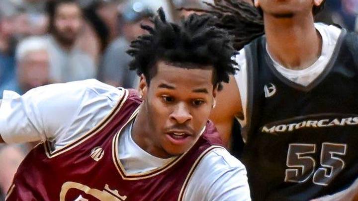 Team Faygo and Michigan State's Jasiah Jervis, center, moves through the Team Motorcars defense during the Moneyball Pro-Am on Tuesday, June 23, 2026, at Holt High School.