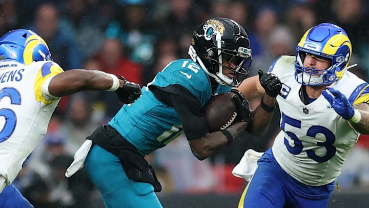 [US, Mexico & Canada customers only] Oct 19, 2025; London, United Kingdom; Jacksonville Jaguars wide receiver Travis Hunter (12) runs with the ball against Los Angeles Rams safety Kamren Kinchens (26) and linebacker Nate Landman (53) during the second half during a NFL International Series game at Wembley Stadium. Mandatory Credit: Andrew Boyers-Reuters via Imagn Images