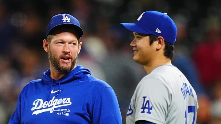 Los Angeles Dodgers pitcher Clayton Kershaw (22) and designated hitter Shohei Ohtani (17) celebrate defeating the Colorado Rockies at Coors Field on Sept. 28, 2024.