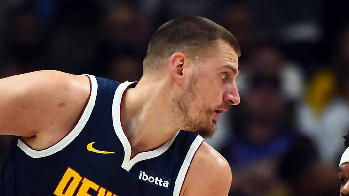 Mar 27, 2026; Denver, Colorado, USA; Denver Nuggets center Nikola Jokic (15) holds the ball as he is defended by Utah Jazz guard Elijah Harkless (16) during the first half at Ball Arena. Mar 27, 2026; Denver, Colorado, USA; Denver Nuggets center Nikola Jokic (15) holds the ball as he is defended by Utah Jazz guard Elijah Harkless (16) during the first half at Ball Arena.
