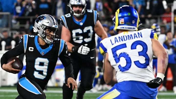 Jan 10, 2026; Charlotte, NC, USA;Carolina Panthers quarterback Bryce Young (9) rushes the ball against Los Angeles Rams linebacker Nate Landman (53) in the first half during the NFC Wild Card Round game at Bank of America Stadium. Mandatory Credit: Bob Donnan-Imagn Images Jan 10, 2026; Charlotte, NC, USA;Carolina Panthers quarterback Bryce Young (9) rushes the ball against Los Angeles Rams linebacker Nate Landman (53) in the first half during the NFC Wild Card Round game at Bank of America Stadium. Mandatory Credit: Bob Donnan-Imagn Images