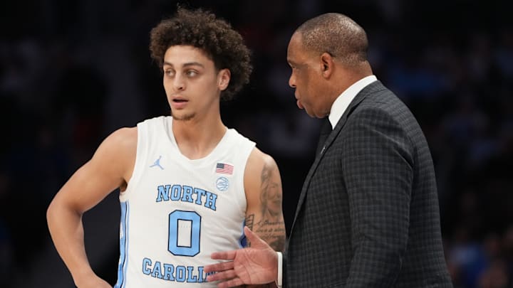 Mar 12, 2026; Charlotte, NC, USA; North Carolina Tar Heels head coach Hubert Davis with guard Kyan Evans (0) in the first half at Spectrum Center. Mandatory Credit: Bob Donnan-Imagn Images Mar 12, 2026; Charlotte, NC, USA; North Carolina Tar Heels head coach Hubert Davis with guard Kyan Evans (0) in the first half at Spectrum Center. Mandatory Credit: Bob Donnan-Imagn Images